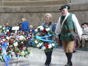 Past Regent Janice Bedwell laying a wreath at a Veteran's Day celebration with a SAR member.